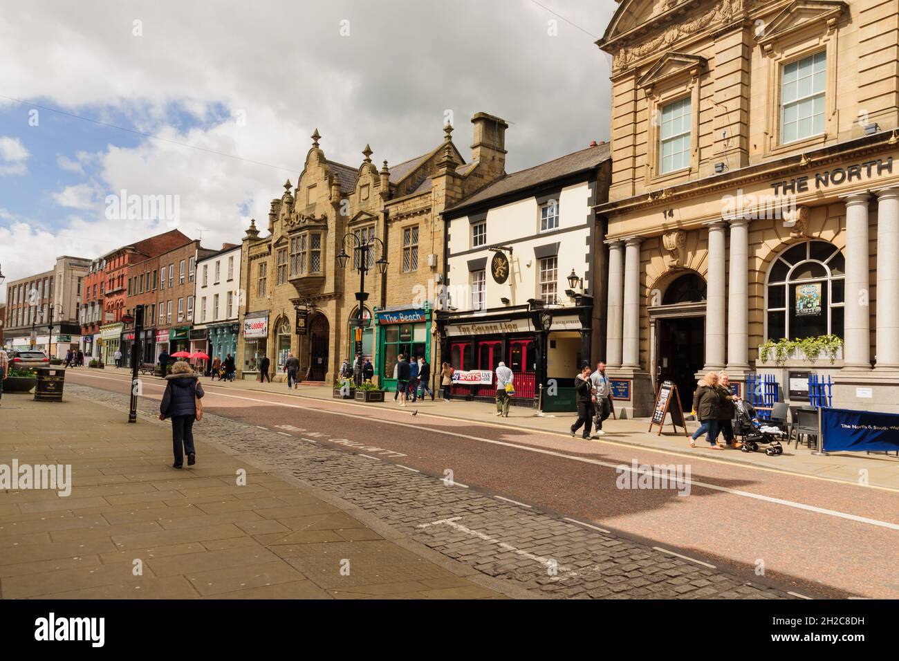 The High Street in Wrexham town centre showing its varied period buildings including the entrance to the indoor market and Golden Lion pub Stock Photo