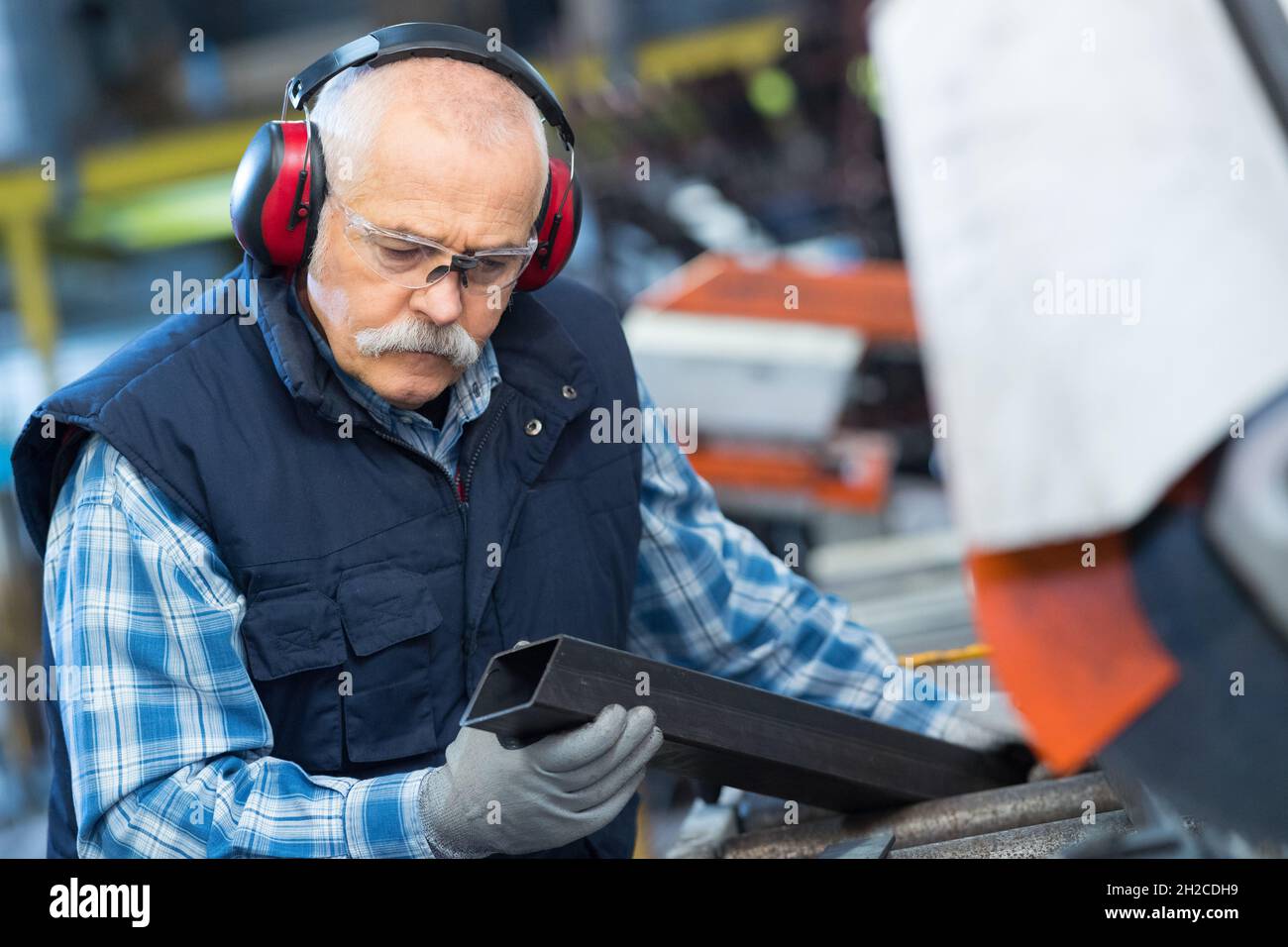 senior worker in metalworking machine Stock Photo