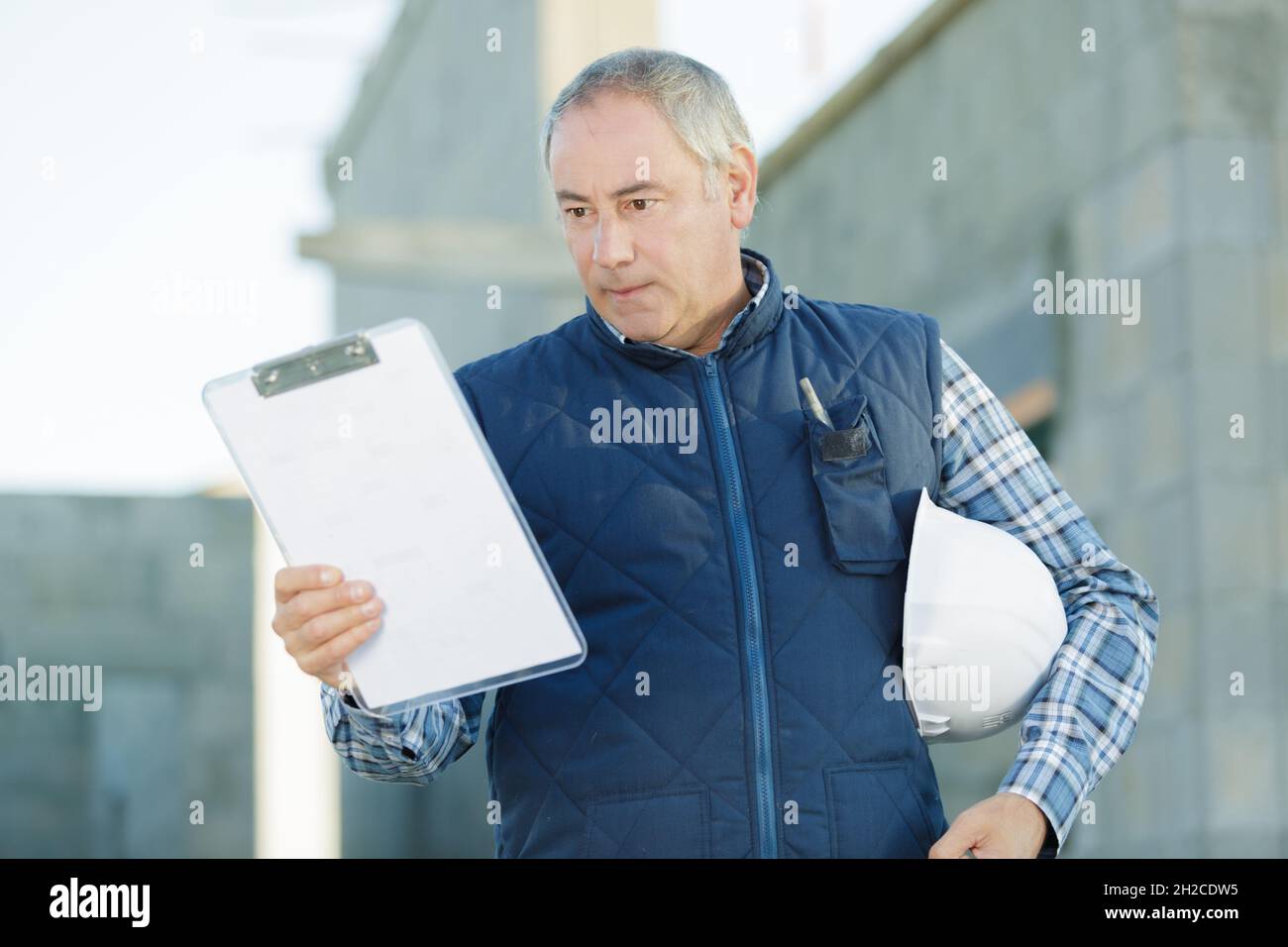 a mature man with clipboard Stock Photo - Alamy