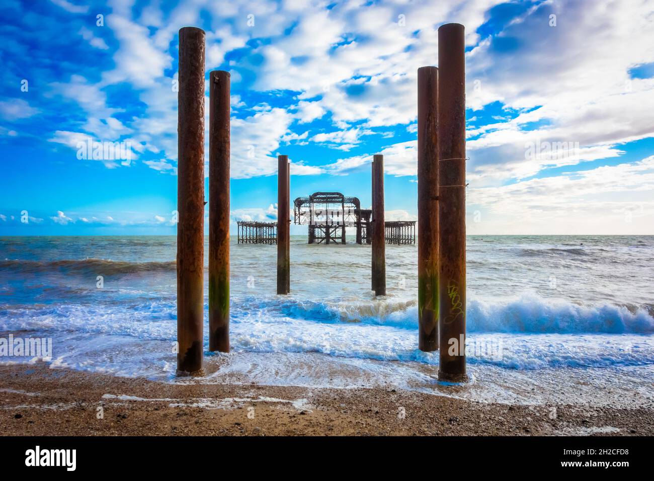 Wide angle image of Brighton west pier with cast iron pillars in the foreground Stock Photo