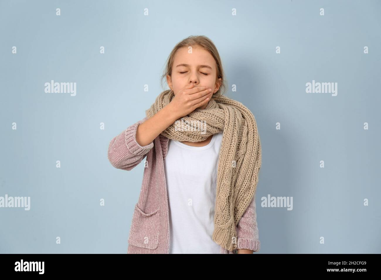 Girl coughing on light background Stock Photo Alamy