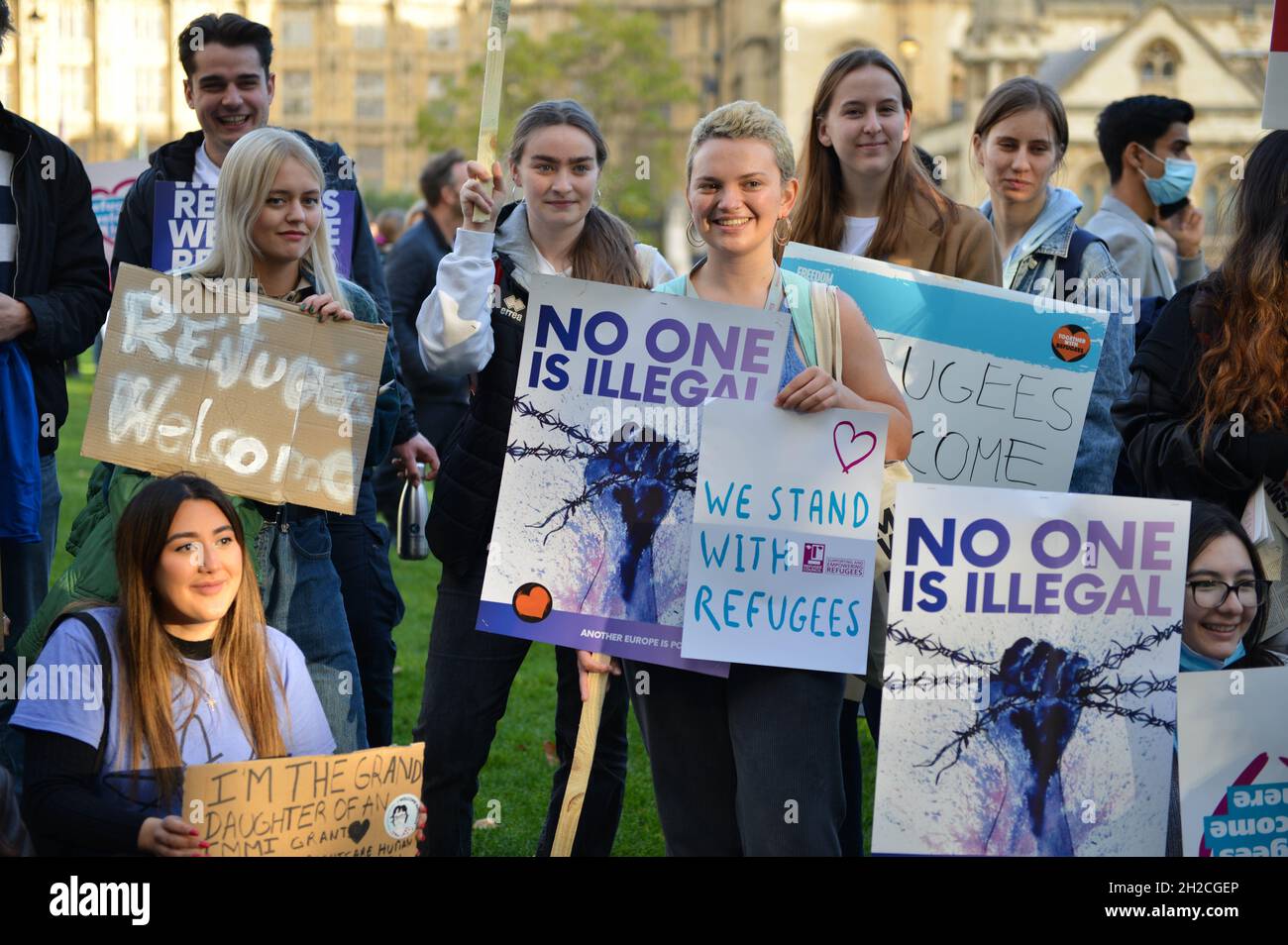 Protesters hold placards during the demonstration. Demonstrators gathered in Parliament Square in support of refugees. Stock Photo