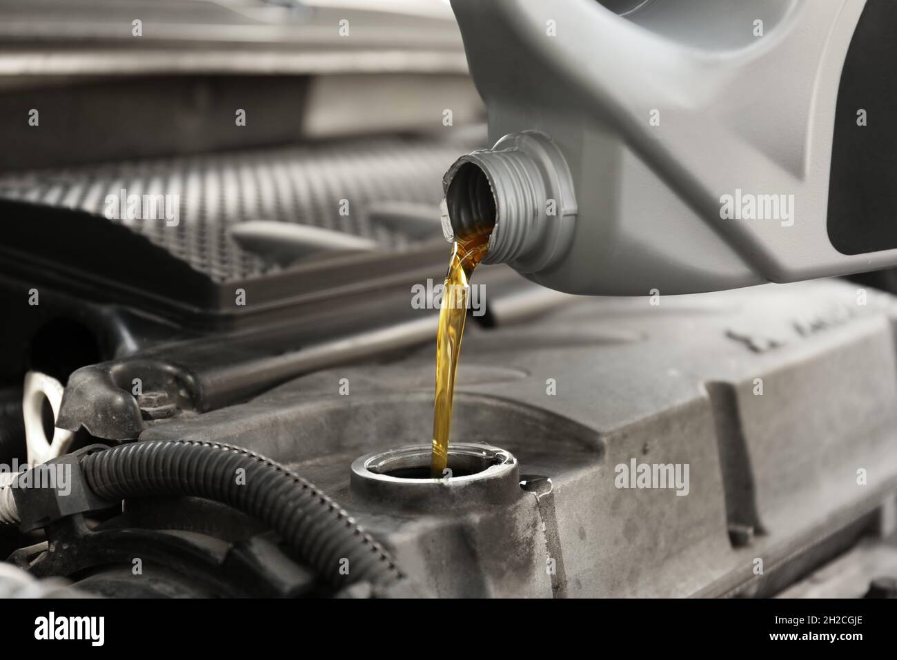 Pouring oil into car engine, closeup Stock Photo Alamy