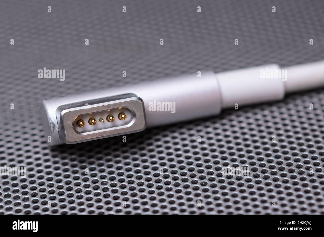 Close-up Apple MagSafe power connector for MacBook Pro on metallic mesh surface Stock Photo - Alamy