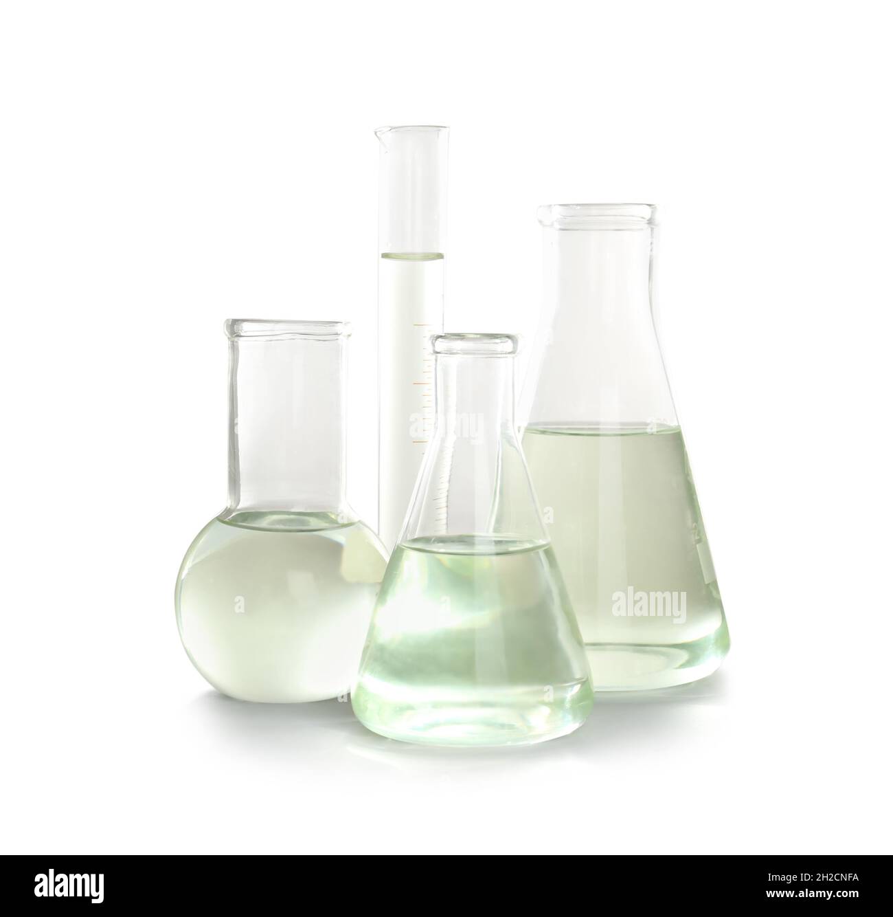 Laboratory glassware with liquid on white background. Chemical analysis ...