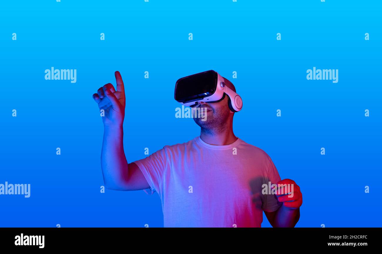 young man using virtual reality glasses using virtual touch screen. Stock Photo