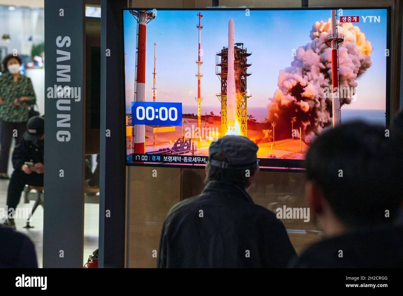 People watch the launch of The Korean Satellite Launch Vehicle II, known as Nuri, on TV at Seoul Railway Station. South Korea launched its first homegrown rocket The Korean Satellite Launch Vehicle II, known as NURI. (Photo by Simon Shin / SOPA Images/Sipa USA) Stock Photo