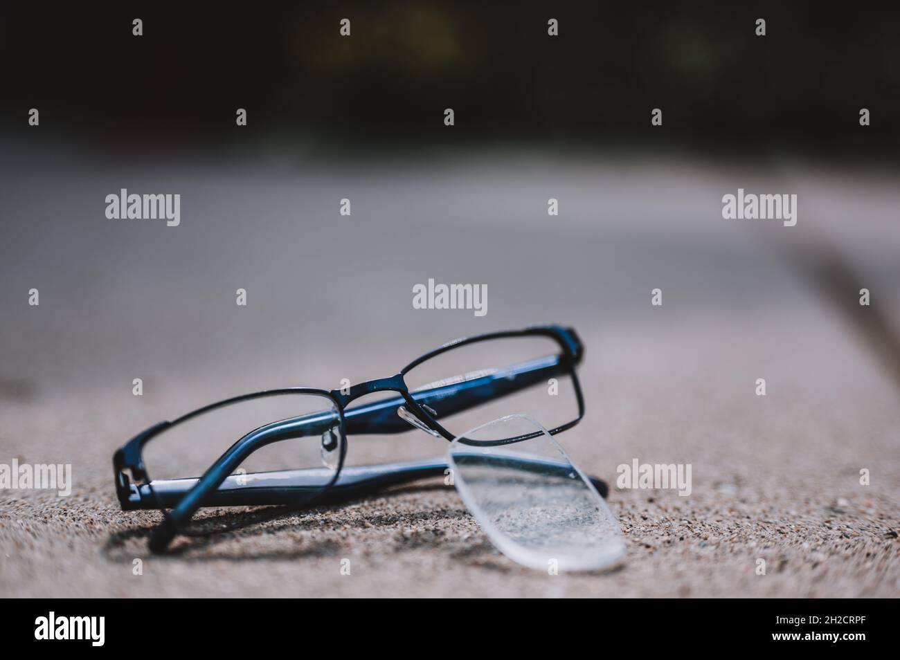 Selective focus on damaged glasses with scratched lens popped out Stock
