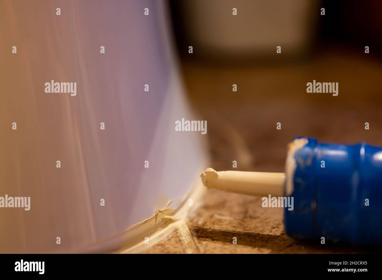 Selective focus on silicone caulking ready to be applied around the