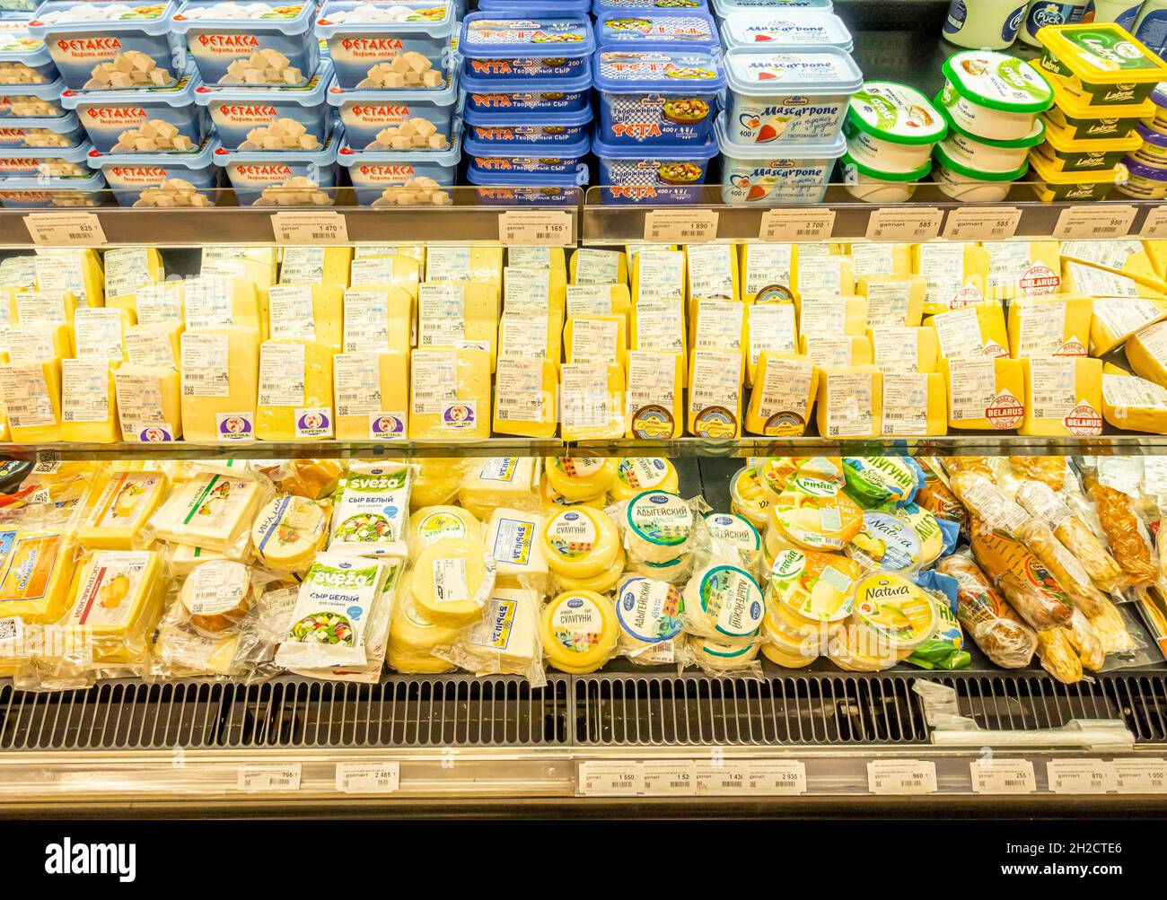 Variety of cheese and butter on display sold in the indoors Galmart supermarket in Almaty, Kazakhstan Stock Photo