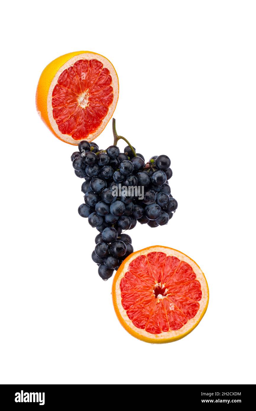 Dark blue grape with red grapefruit isolated on white background Stock Photo