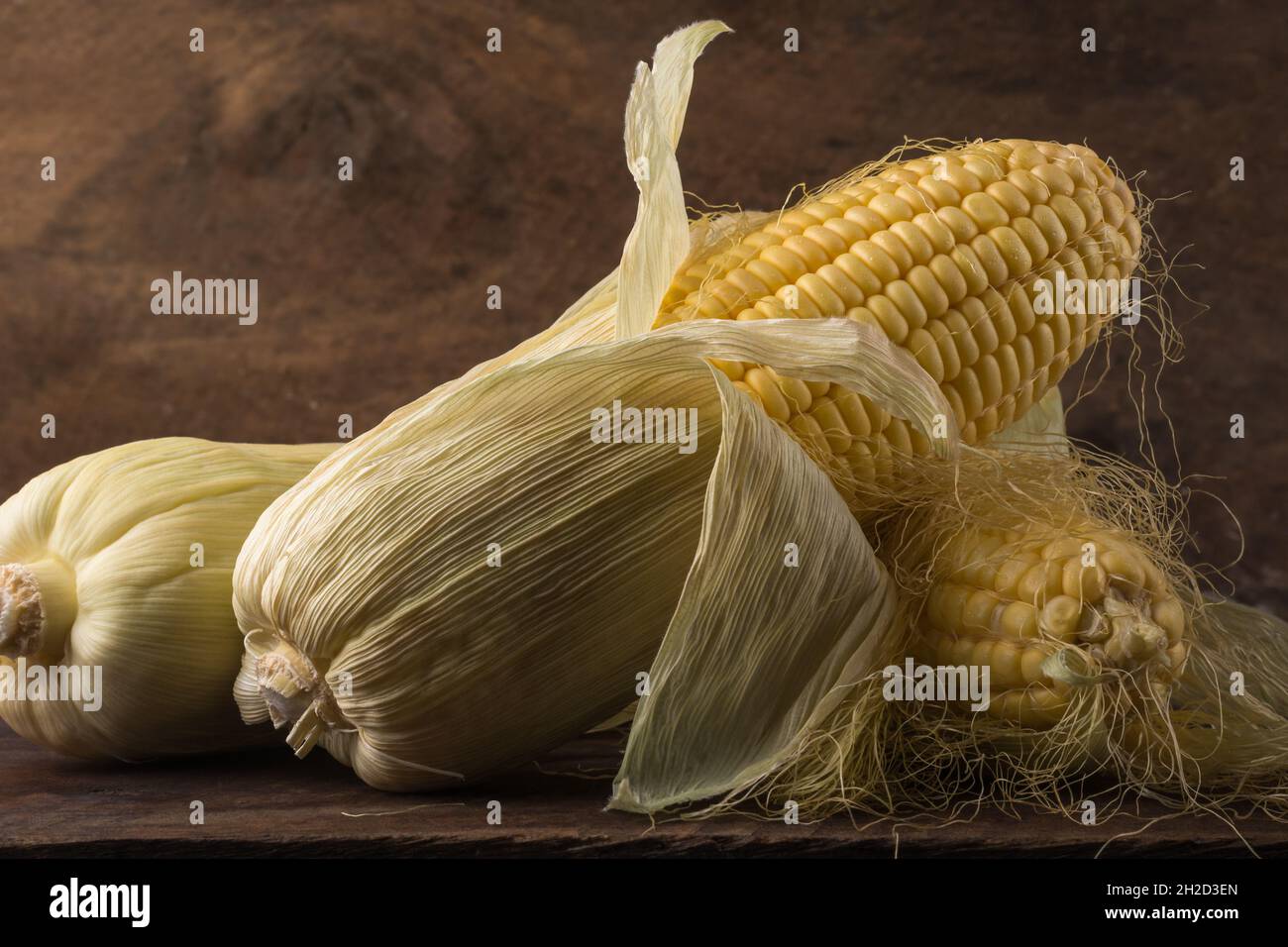 closeup view of corn or maize on a wooden table top, popular starchy