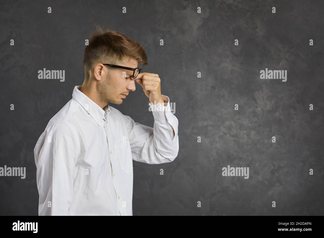 Unhealthy man feel tired suffer from headache Stock Photo - Alamy