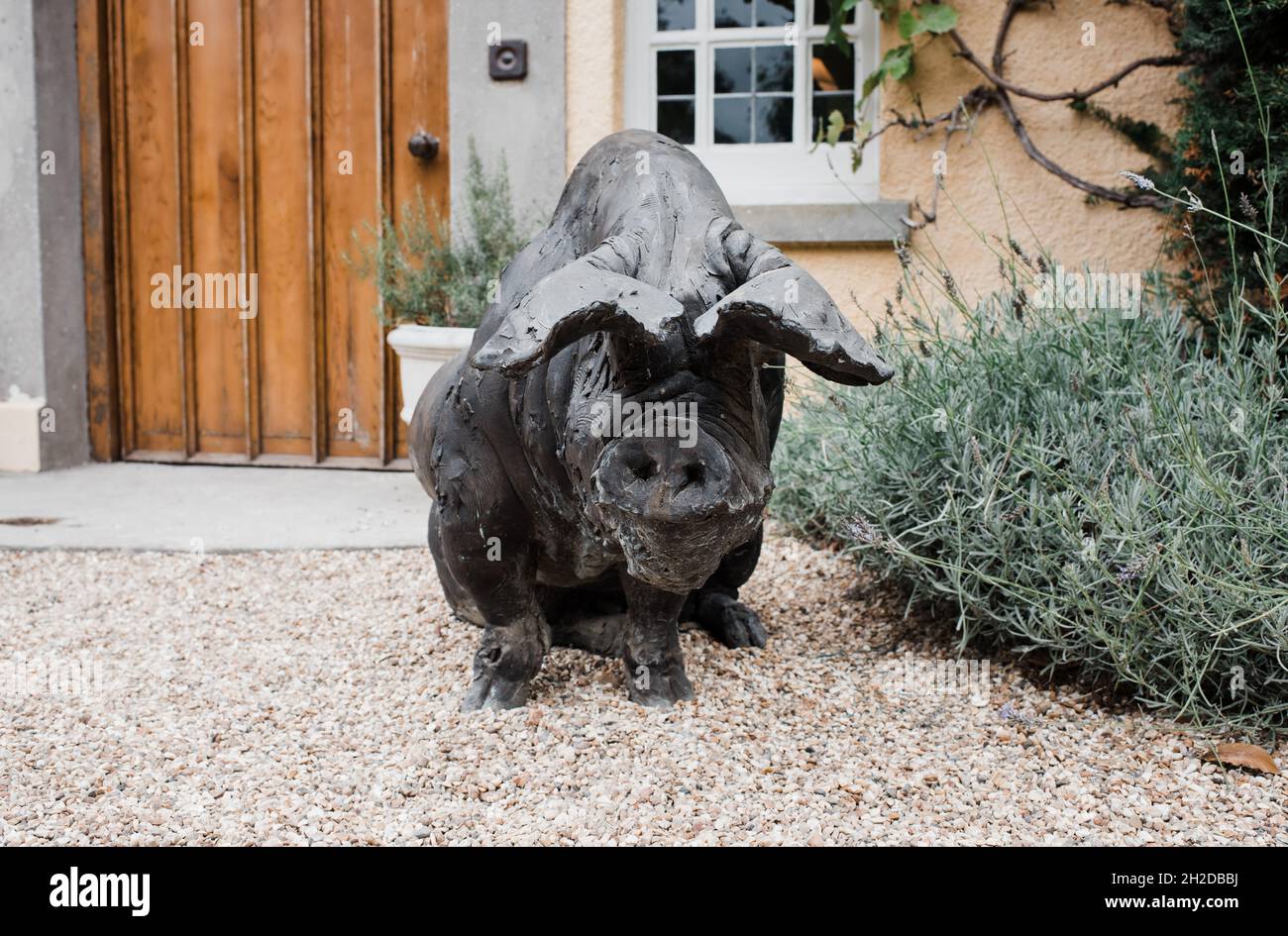 statue of a large pig outside a country home in England Stock Photo