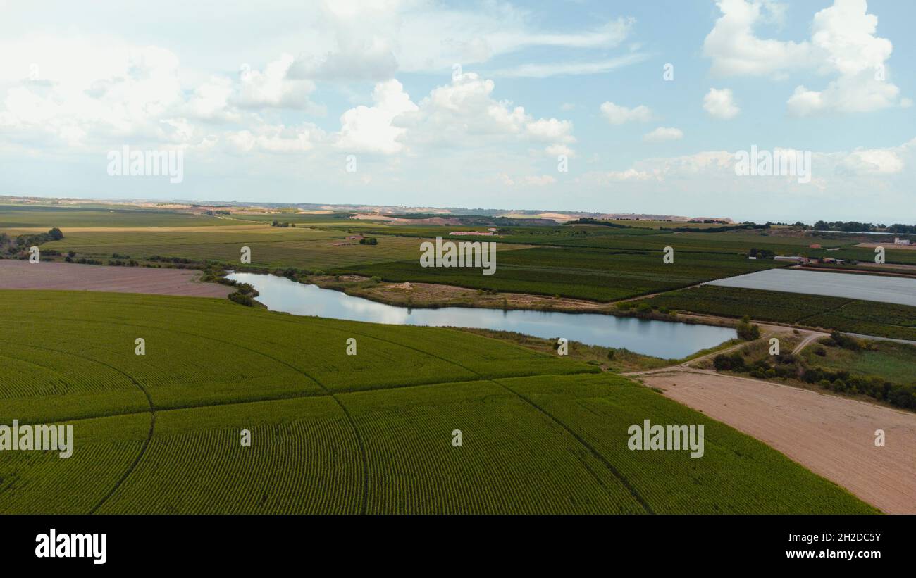 Aerial view of a lake surrounded by fields Stock Photo