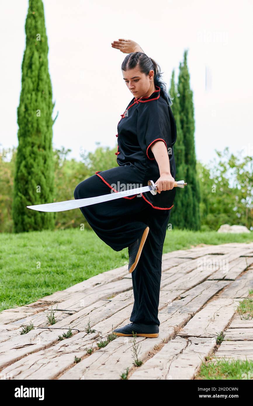 Woman in uniform practicing martial arts with a sword Stock Photo Alamy