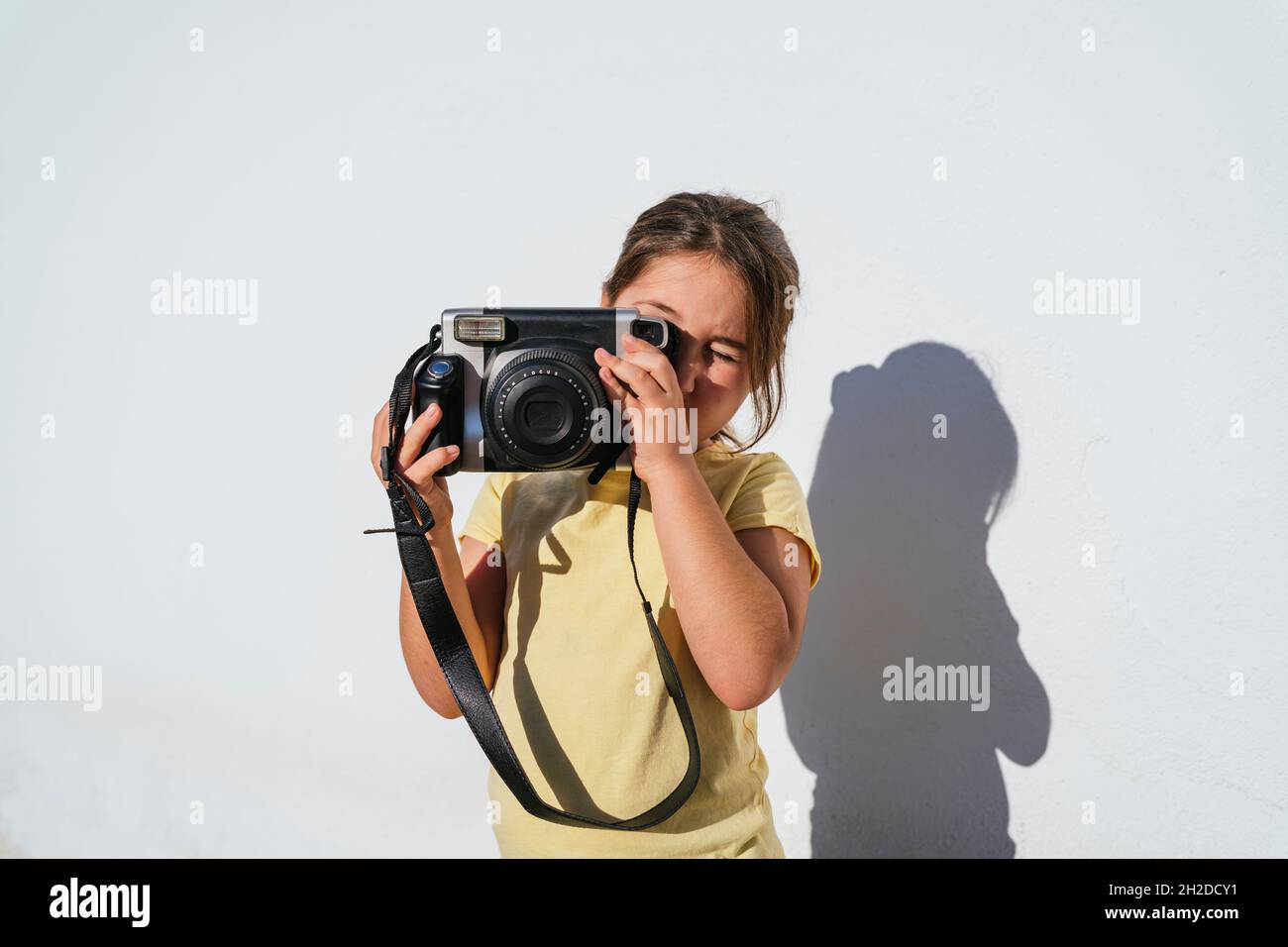 Young girl taking photo with instant camera Stock Photo