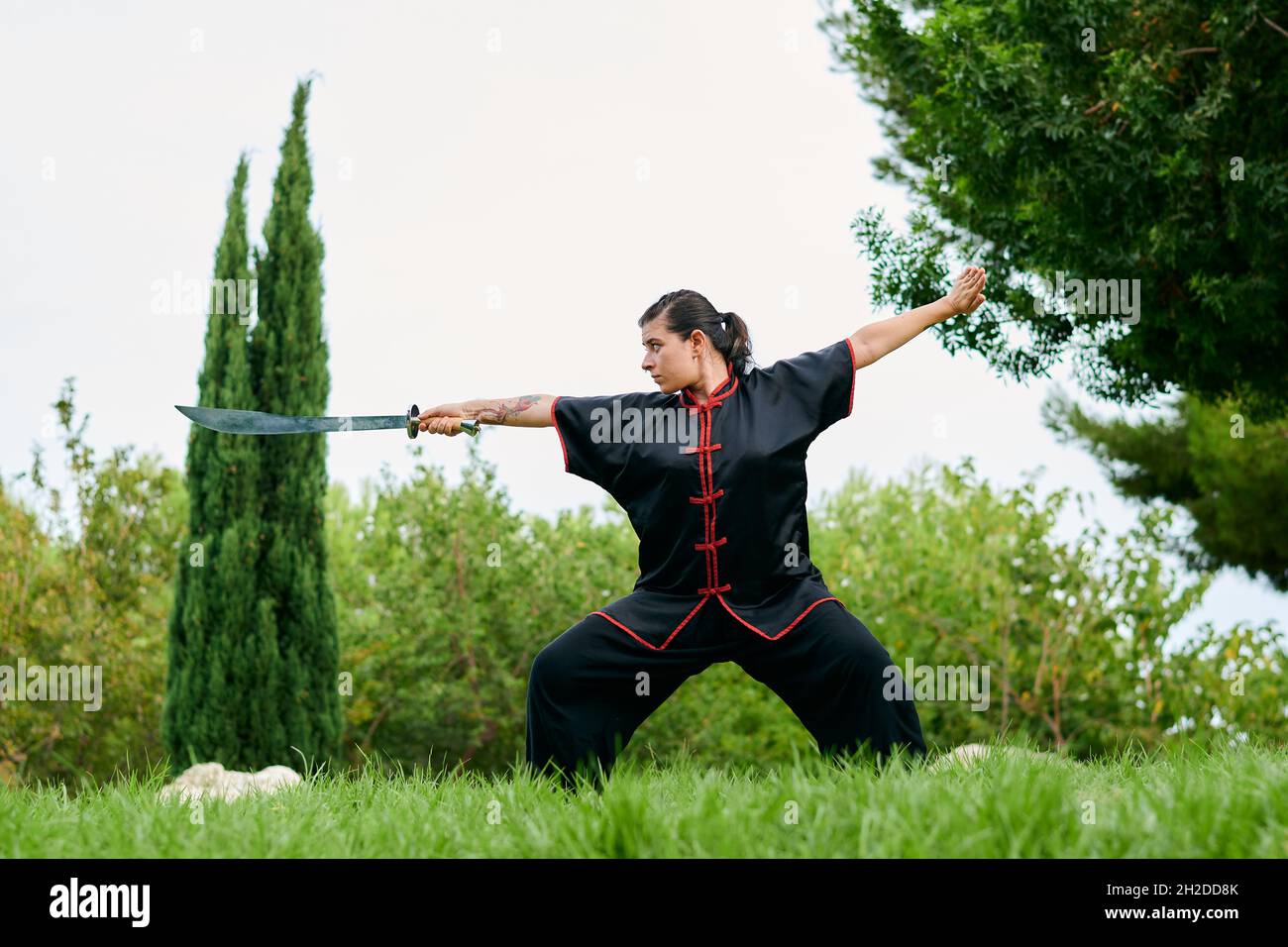 Woman in uniform practicing martial arts with a sword Stock Photo Alamy