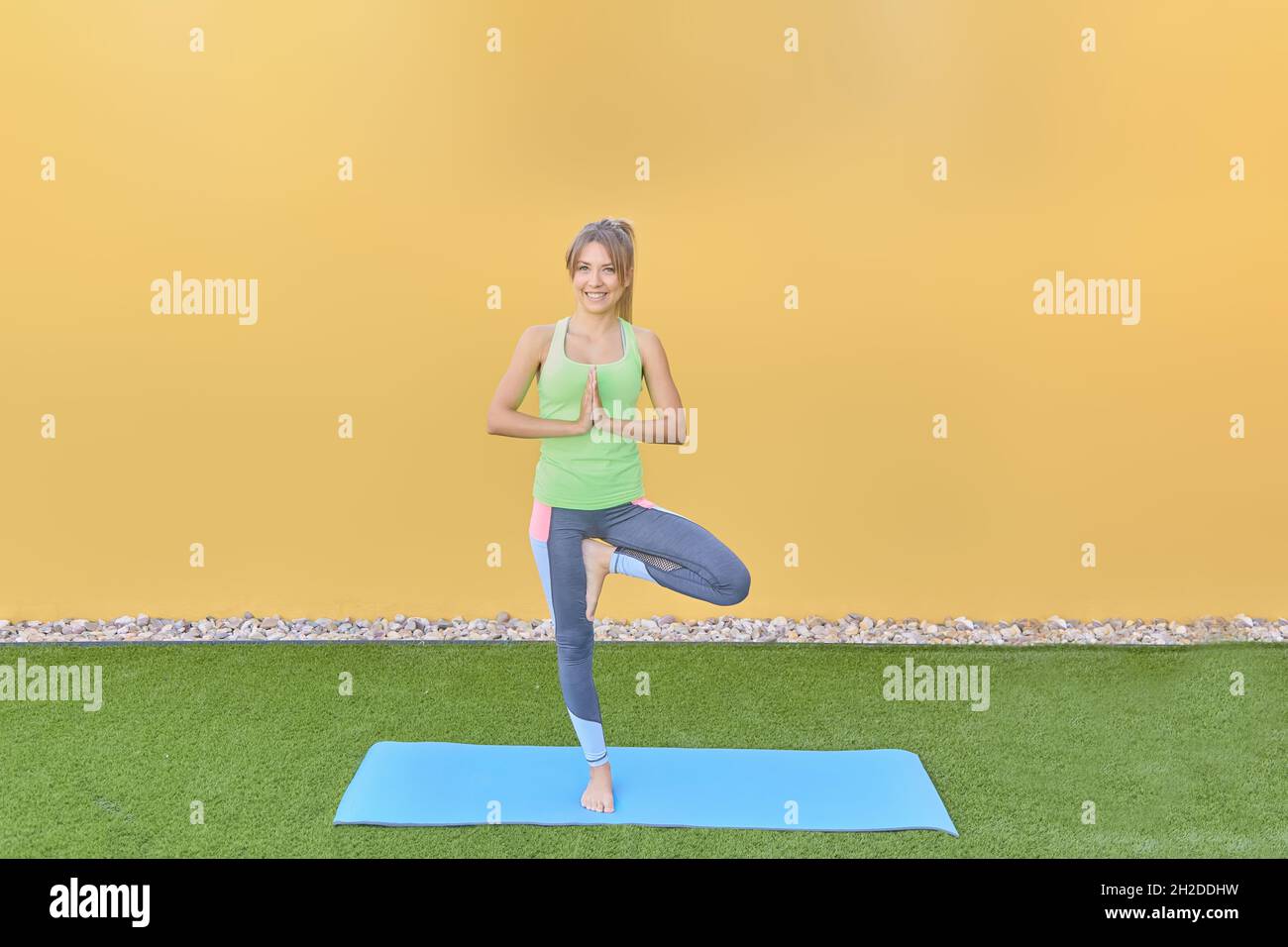 A beautiful girl doing yoga in the garden at home Stock Photo - Alamy