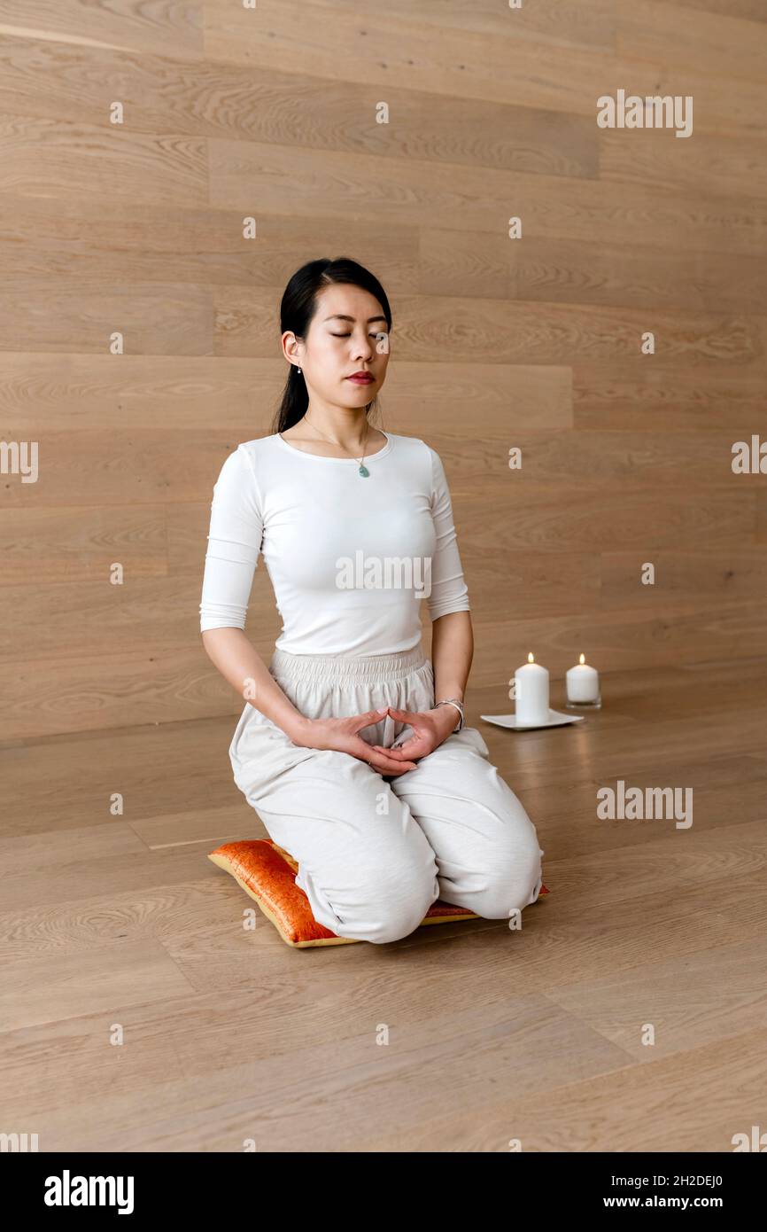 Asian woman practicing yoga, sitting in seiza pose, vajrasana exercise Stock Photo