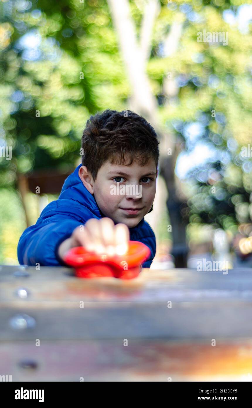 11 year old boy in a blue jacket to learn rock climbing Stock Photo Alamy