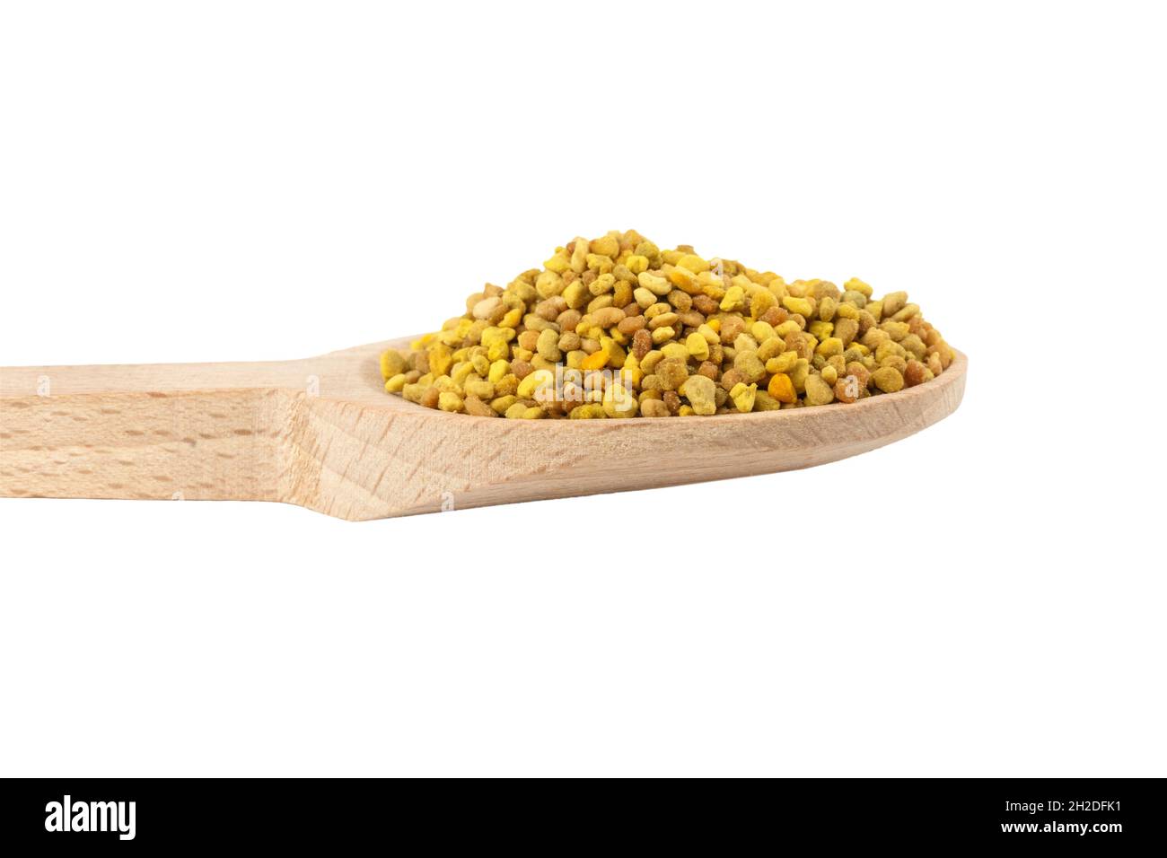 Bee pollen in wooden spoon isolated on white background. Natural herbal medicine to relieve inflammation, influenza, boosts liver health, strengthens Stock Photo