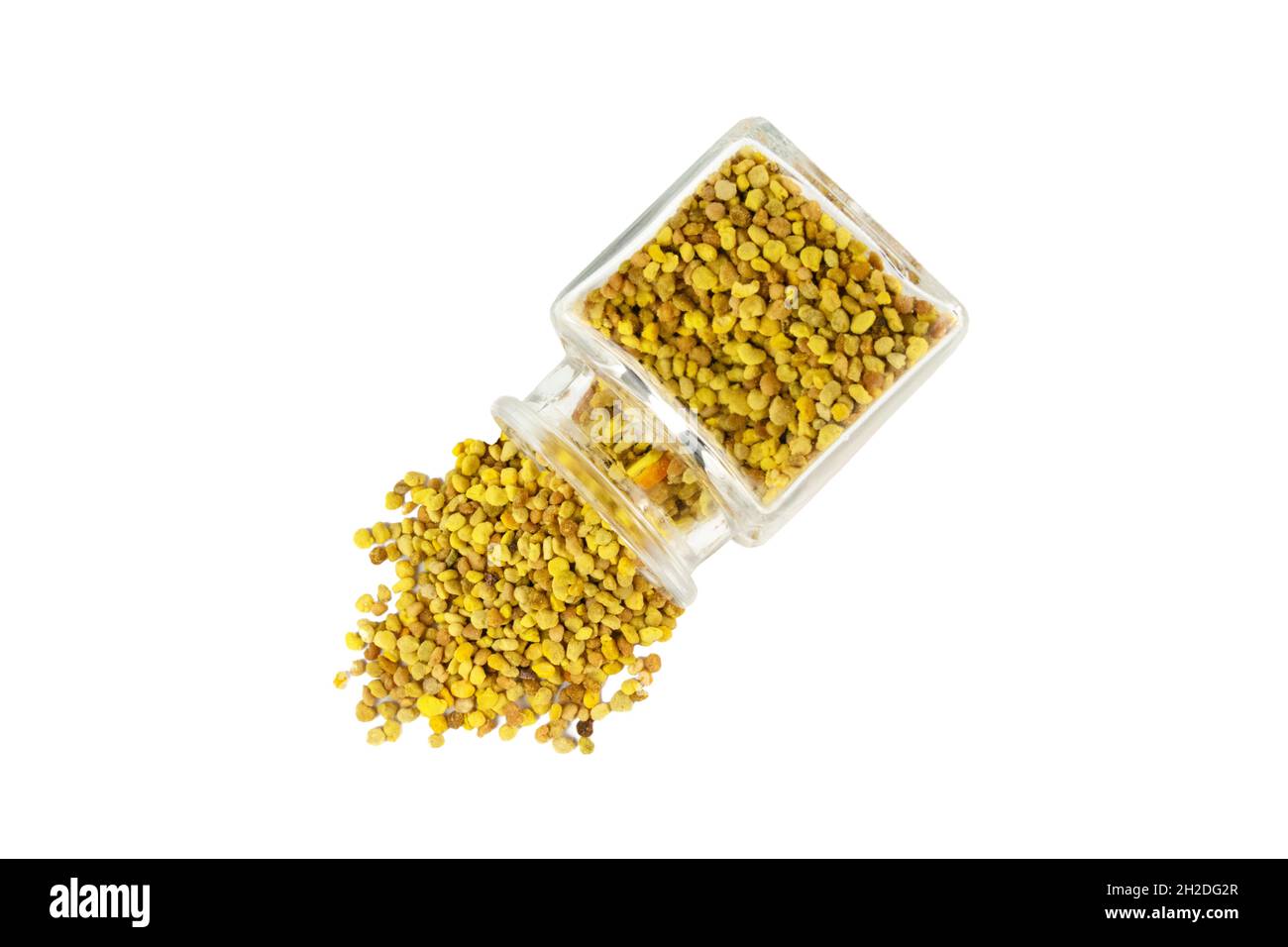 Bee pollen pouring out of the glass jar isolated on white background. natural herbal medicine to relieve inflammation, influenza, boosts liver health, Stock Photo