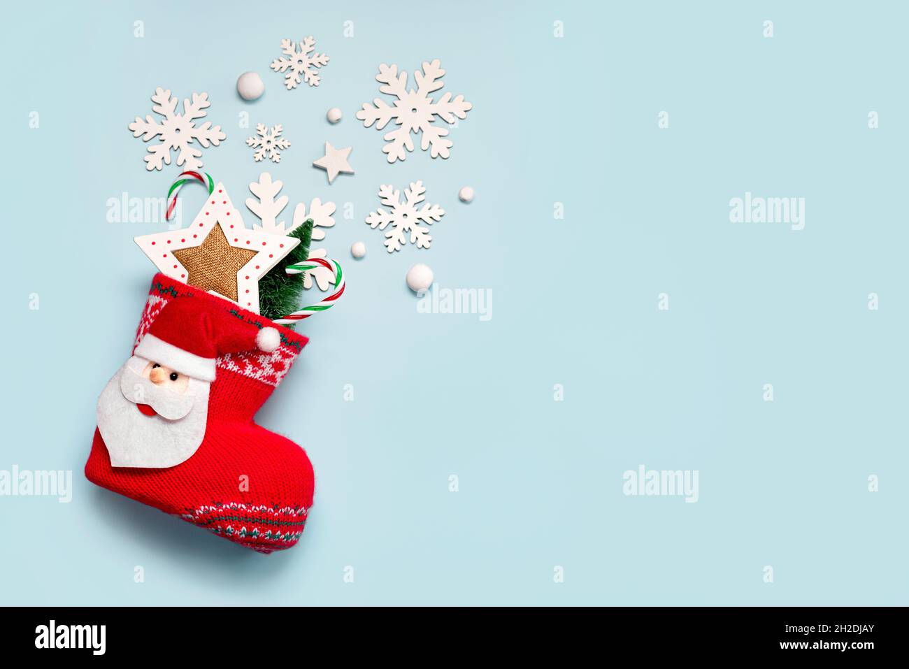 Merry Christmas. Christmas stocking with Christmas decoration and snowflakes with copy space over blue background. Christmas concept background Stock Photo