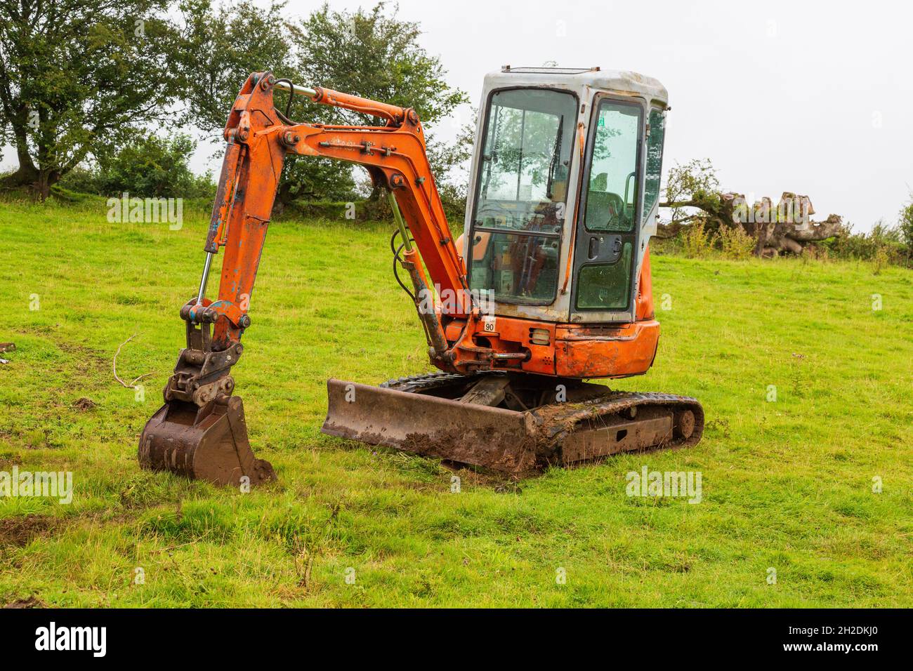 Orange mini digger, High Bickington, Devon, England, United Kingdom