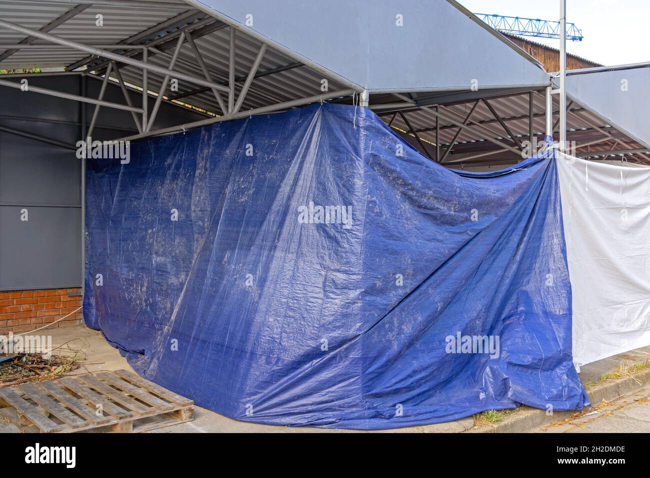 Unfinished Construction Work Covered With Blue Tarp Cover Stock Photo