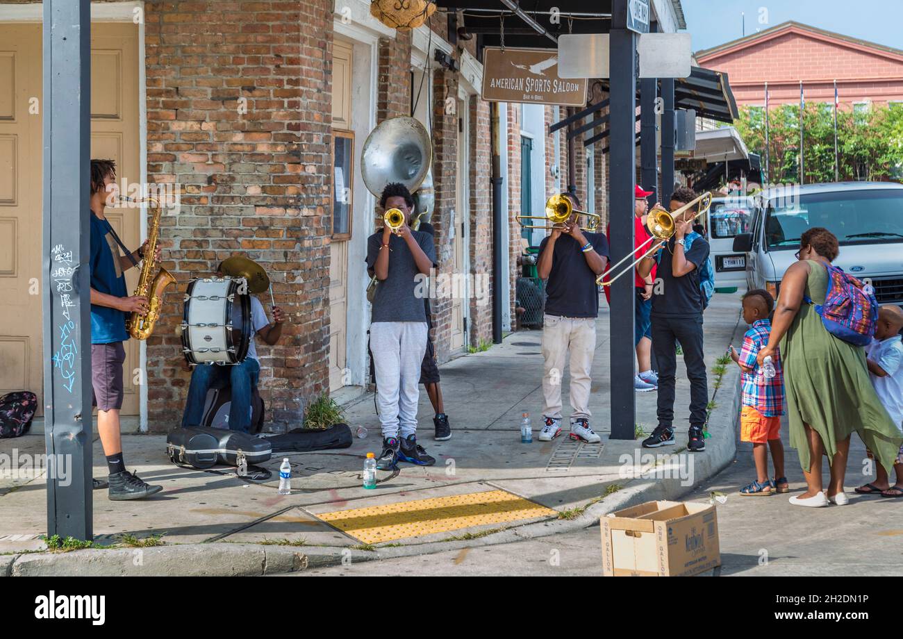 Street musicians play for tips near the French Market in the French Quarter of New Orleans, Louisiana Stock Photo