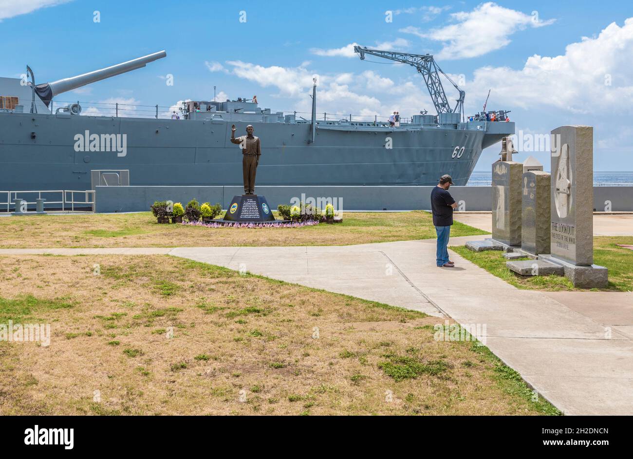Park visitor looking at granite tribute statues at the USS Alabama museum battleship at the Battleship Memorial Park in Mobile, Alabama Stock Photo
