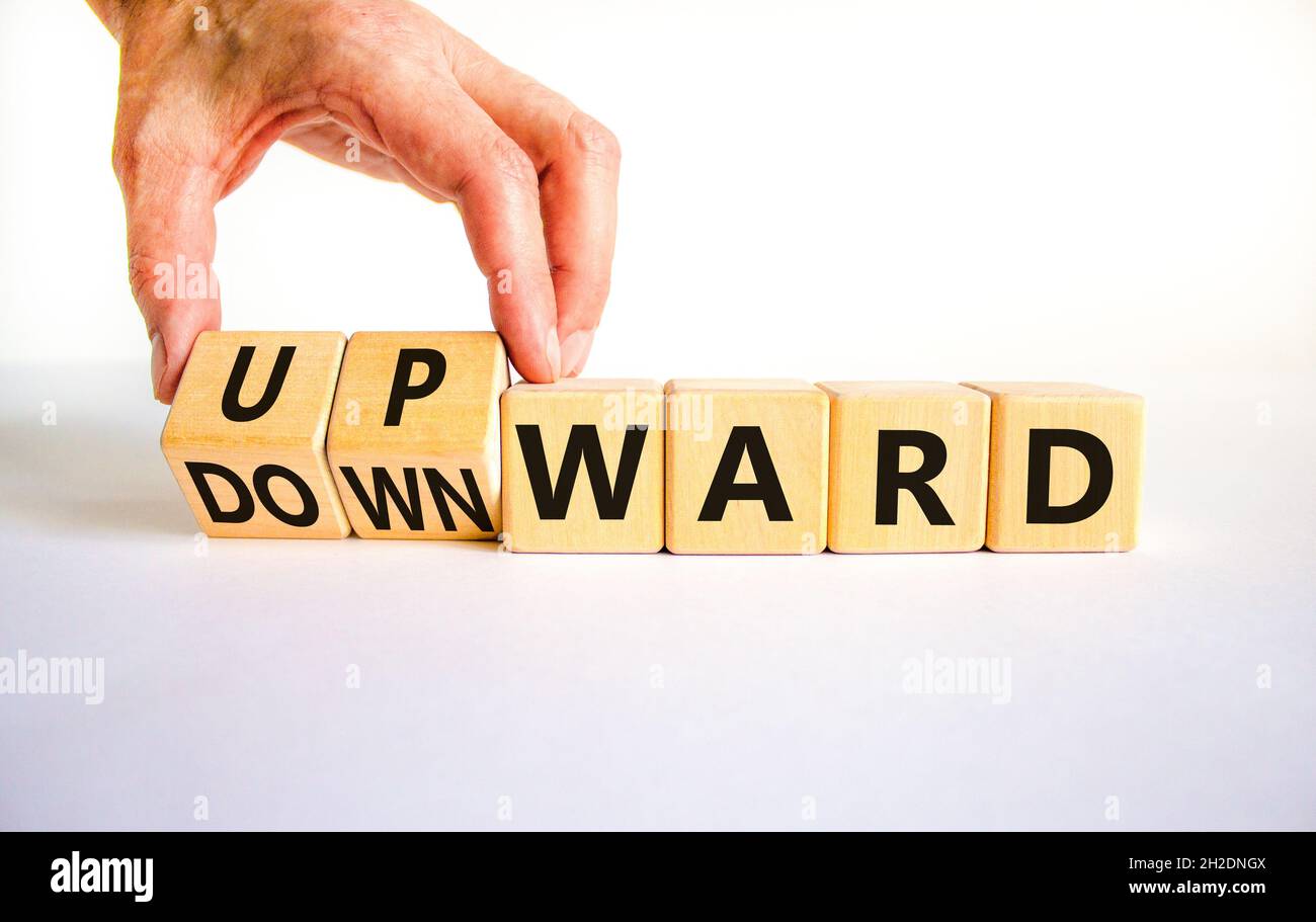 Upwards Table Upward or downward symbol. Businessman turns wooden cubes and changes ...