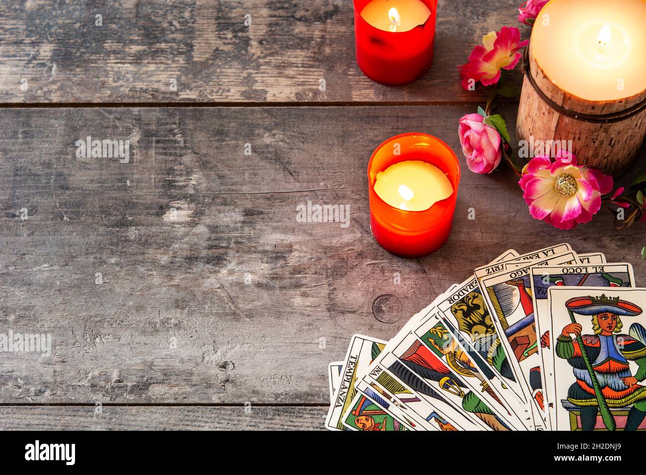 Tarot cards on wooden table with candles Stock Photo - Alamy