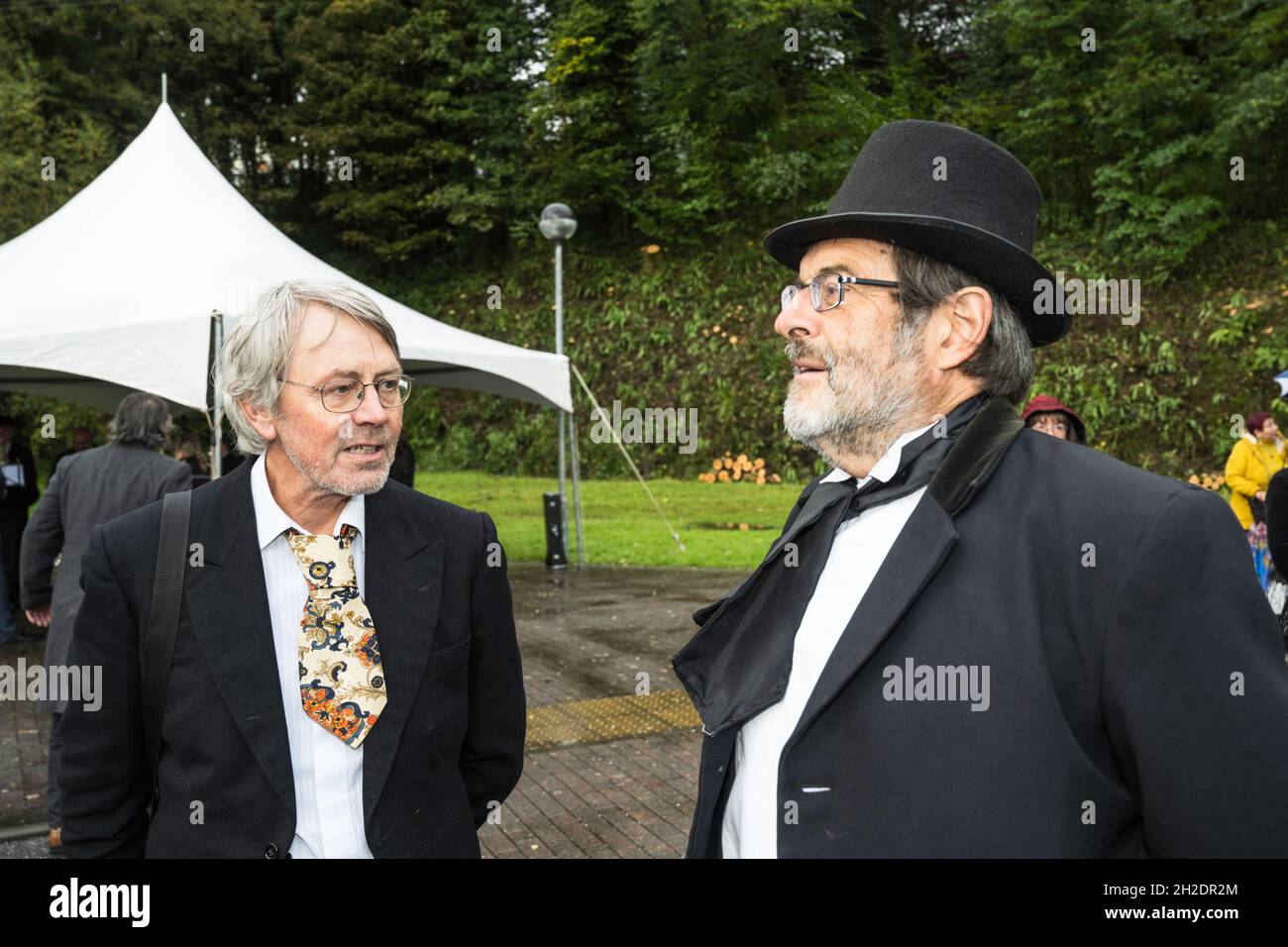 Costumed celebration marking 150 years of rail in Okehampton, Devon. Organiser Paul Vachon, chats to Victorian stationmaster played by Clive Charlton. Stock Photo