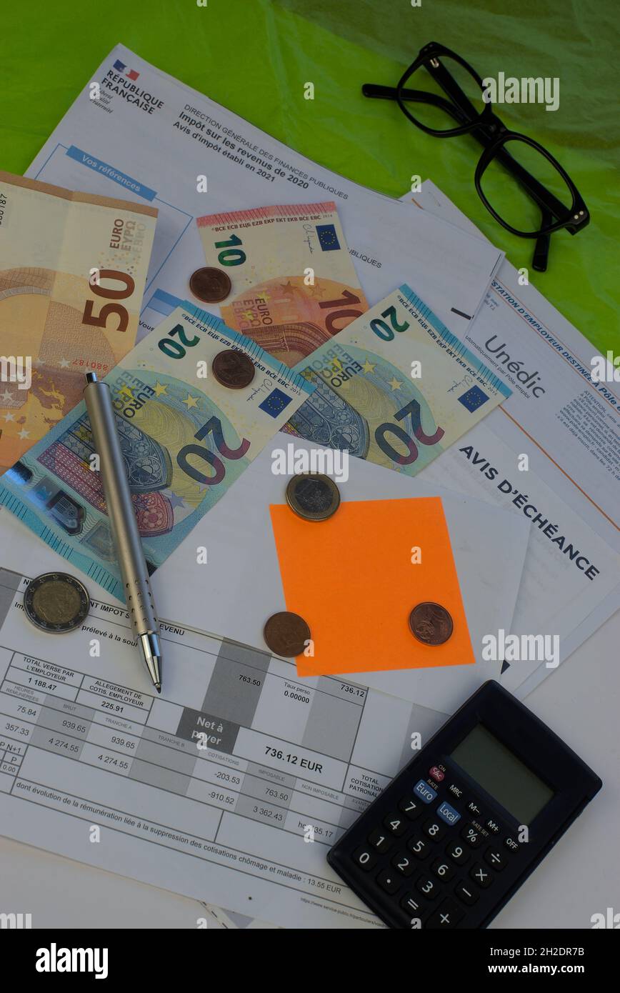 composition on the theme of charges, taxes, debts. With euro banknotes and calculator. Stock Photo