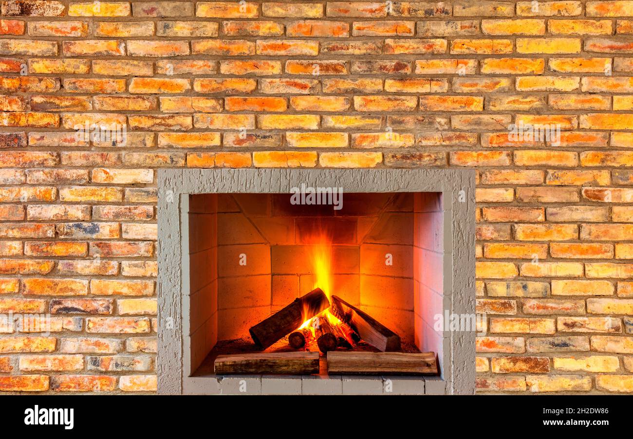 Fireplace in the brick wall Stock Photo