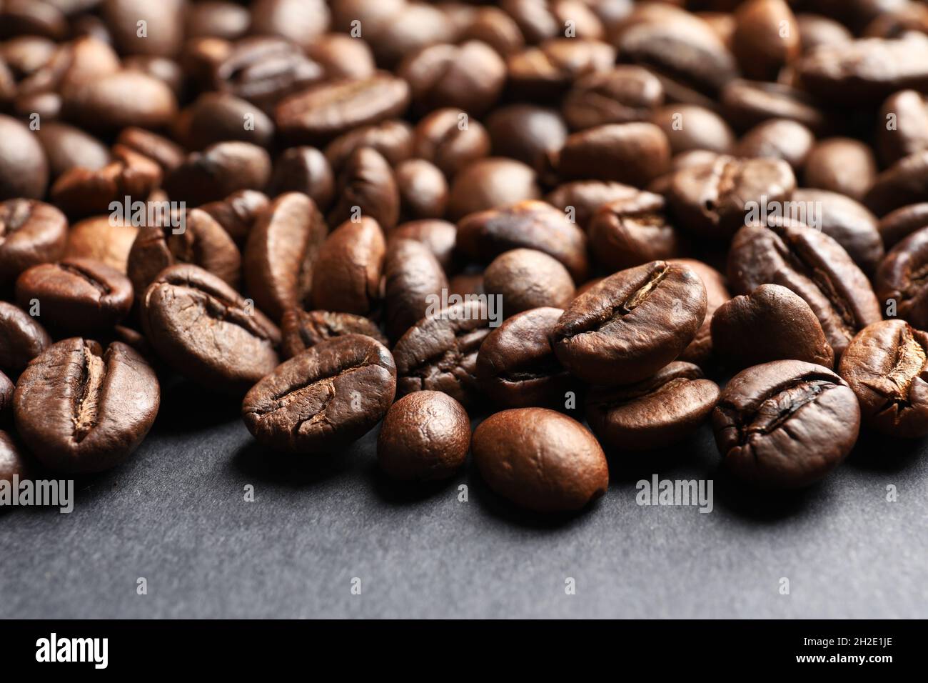 Roasted coffee beans on grey background, closeup Stock Photo - Alamy