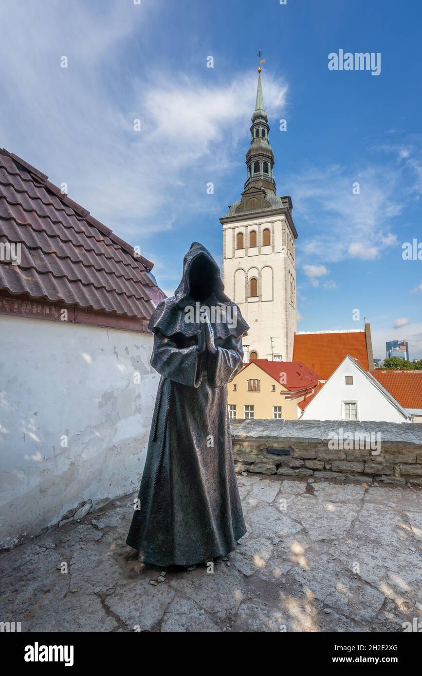 Faceless Monk Sculpture named Three at Danish Kings Garden - Bartholomeus the Praying Monk and St Nicholas Church - Tallinn, Estonia Stock Photo