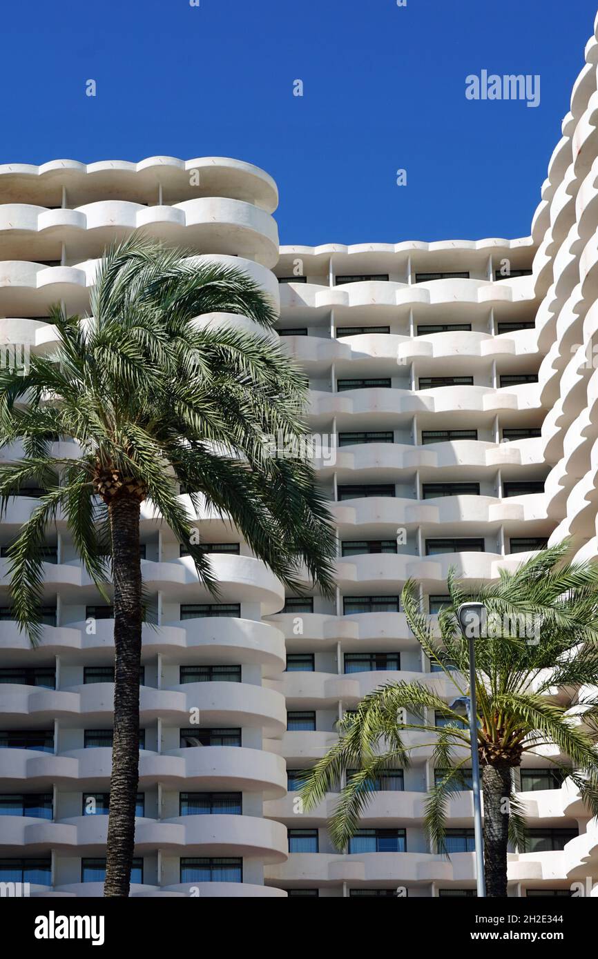 White hotel building with palm trees. Tropical resort Stock Photo - Alamy