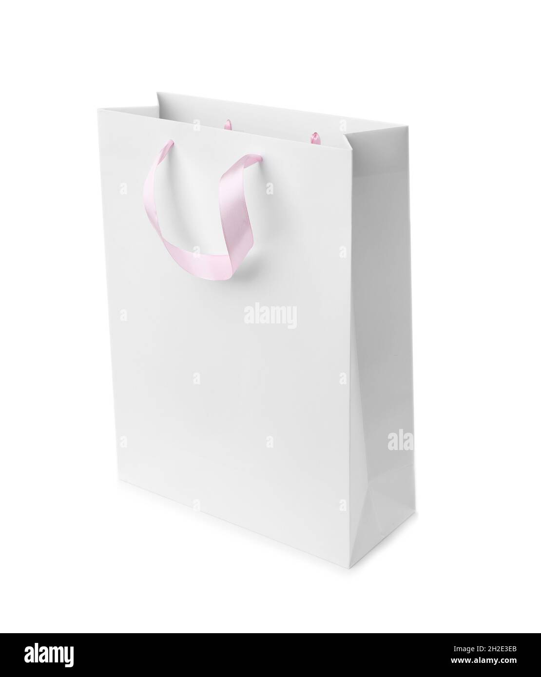 Paper shopping bag with ribbon handles on white background. Mockup for
