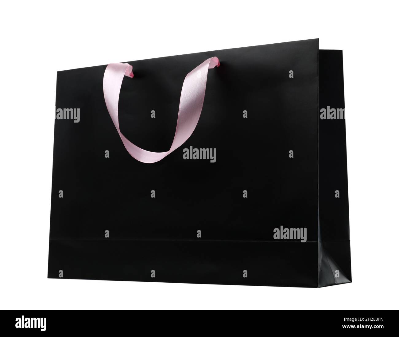 Paper shopping bag with ribbon handles on white background. Mockup for