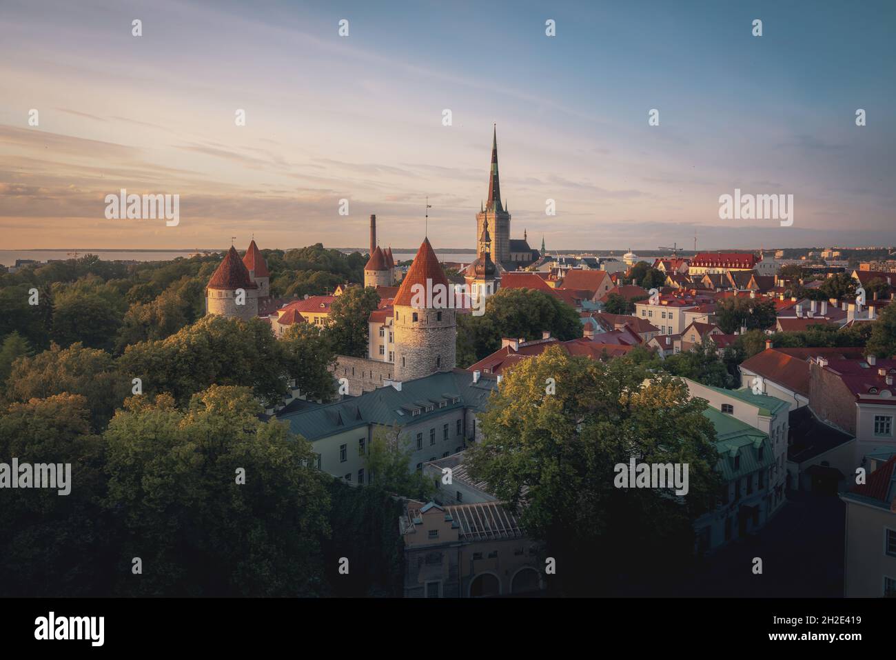 Aerial view of Tallinn at sunset with many towers of Tallinn City Wall and St Olaf Church Tower - Tallinn, Estonia Stock Photo