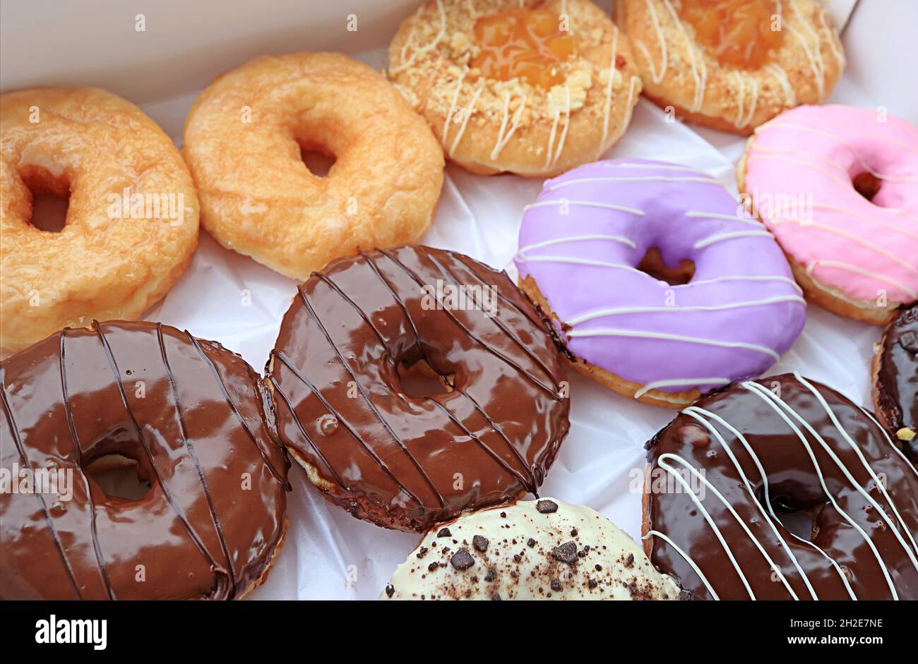 Closeup of delectable assorted doughnuts in a box Stock Photo