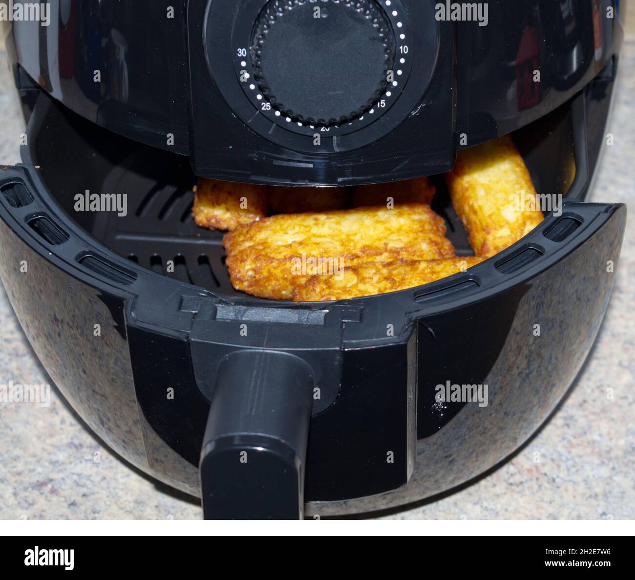 Hot air fryer with potato sticks Stock Photo Alamy