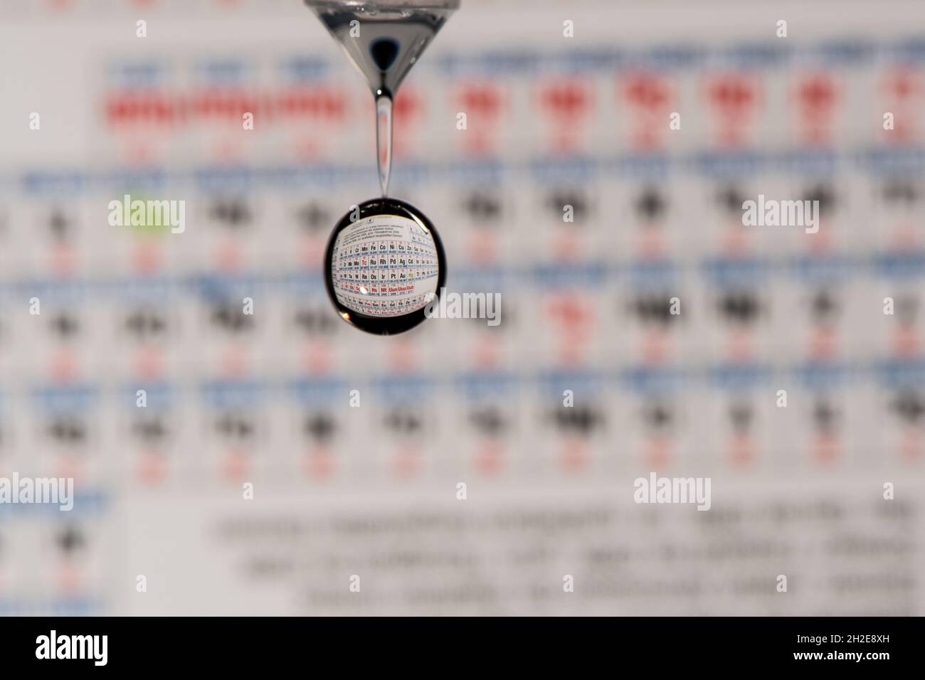 periodic table ob elements refraction in a falling water droplet Stock Photo