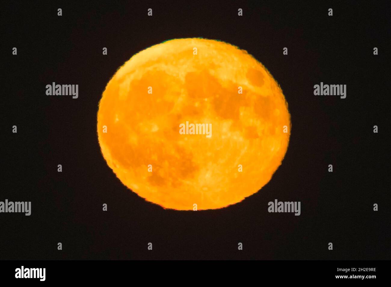 Weymouth, Dorset, UK.  21st October 2021.  UK Weather.  The almost full Hunter’s Moon is the clear night sky above Weymouth in Dorset.  Picture Credit: Graham Hunt/Alamy Live News Stock Photo