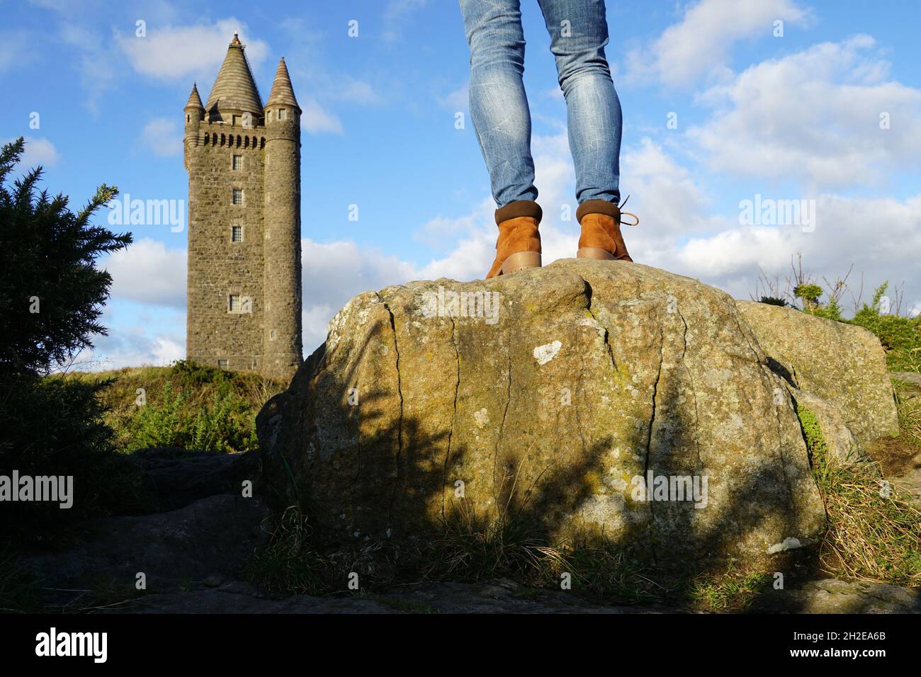 Hiker woman legs in boots on a stone in Scrabo Country Park, Northern Ireland Stock Photo