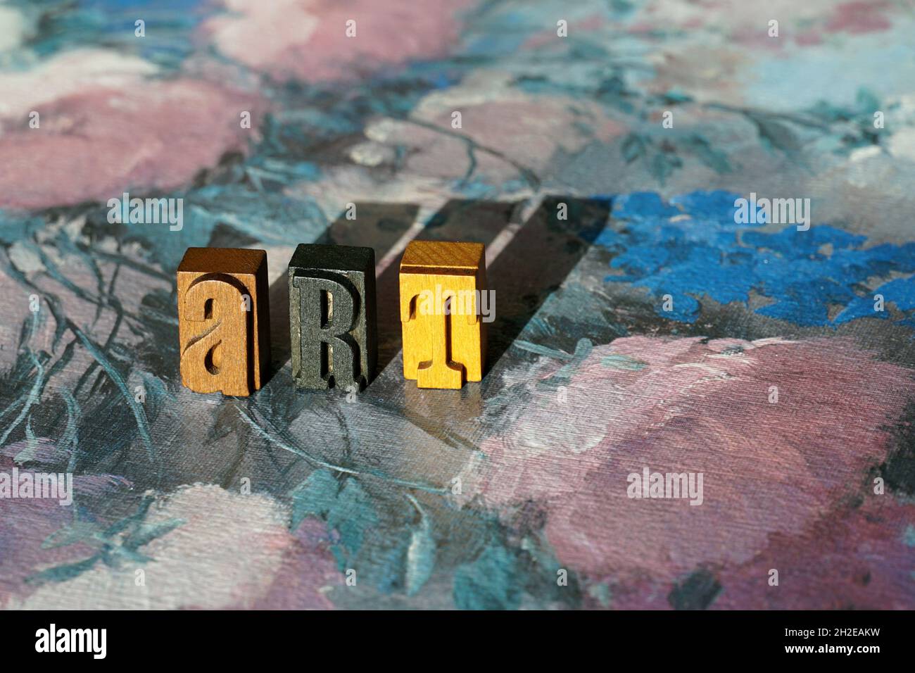 Word ART made of letterpress blocks with its shadows on an oil painting Stock Photo
