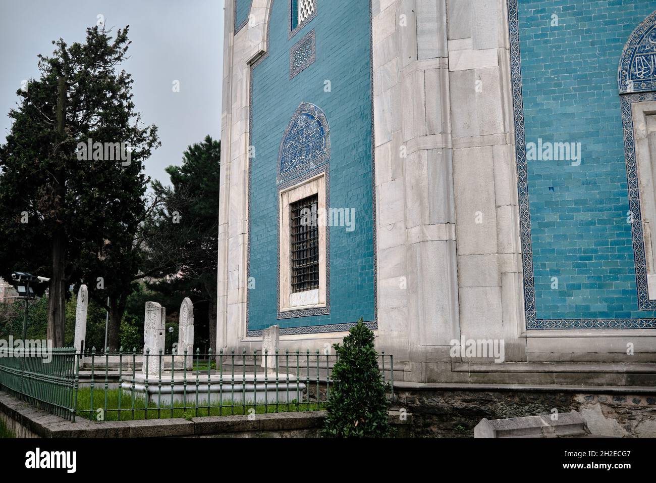 Tombstone or gravestone written by arabic letters in ottoman language in Bursa green tomb (Yesil Turbe) with iznik pottery (cini) covered tomb wall Stock Photo